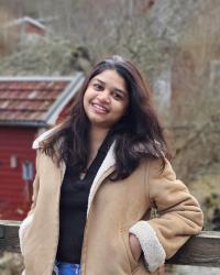 Woman in a tan jacket 
